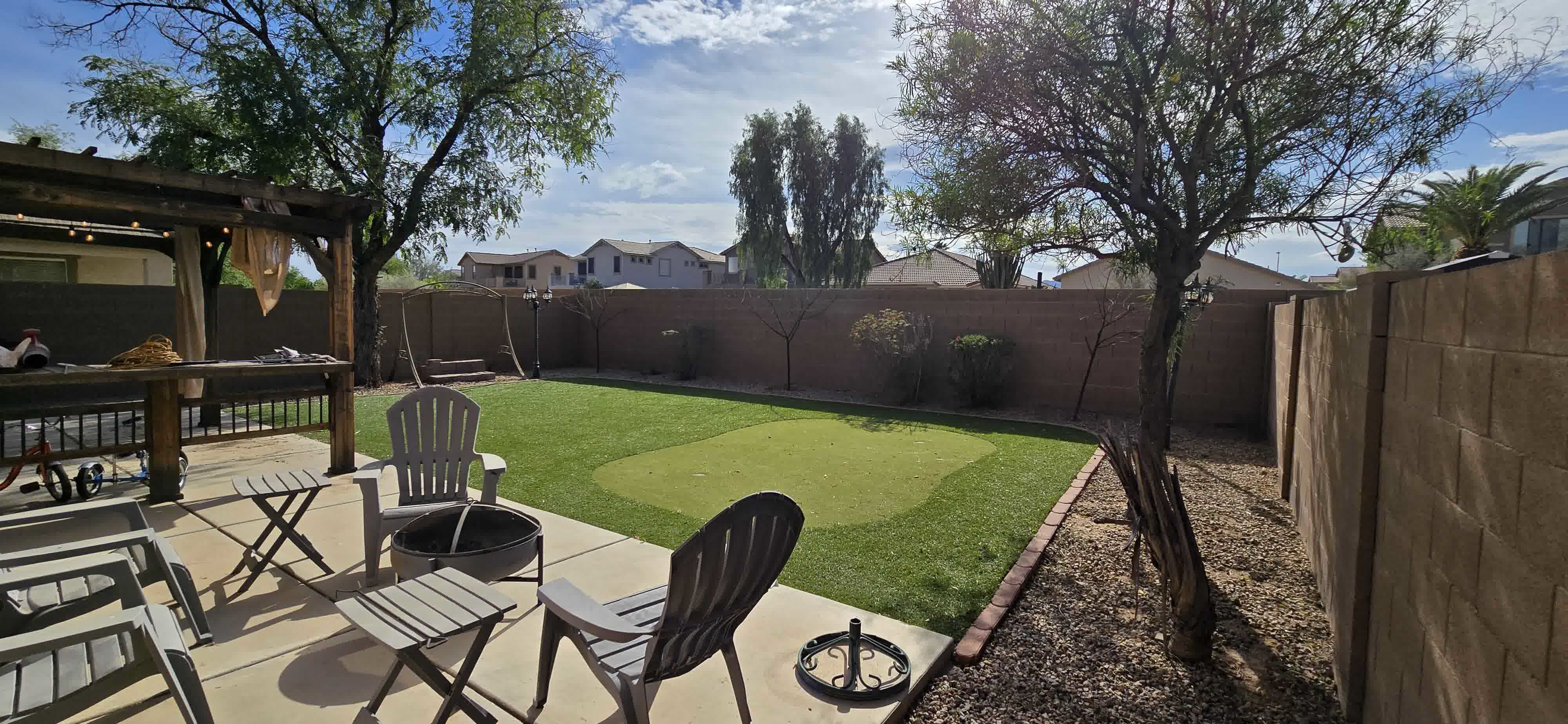 Landscaped Phoenix yard with green lawn and mature trees